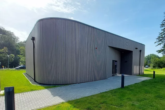 Building made of wood on a sunny day. Photograph. 